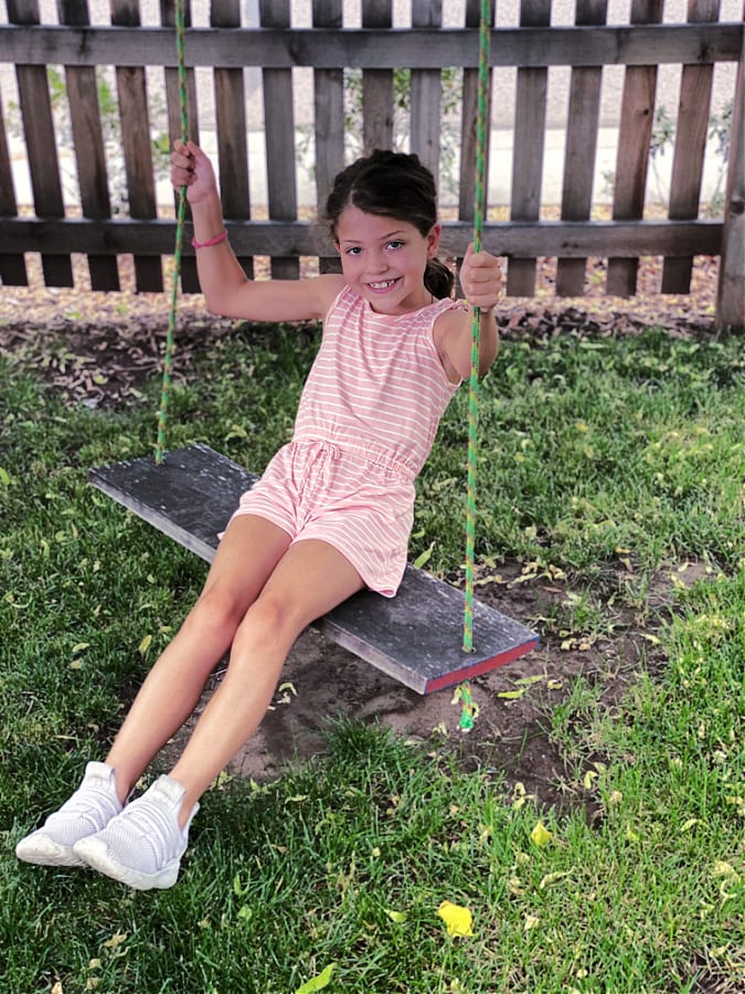 Our youngest, Crosby on the swing in front of our new house!