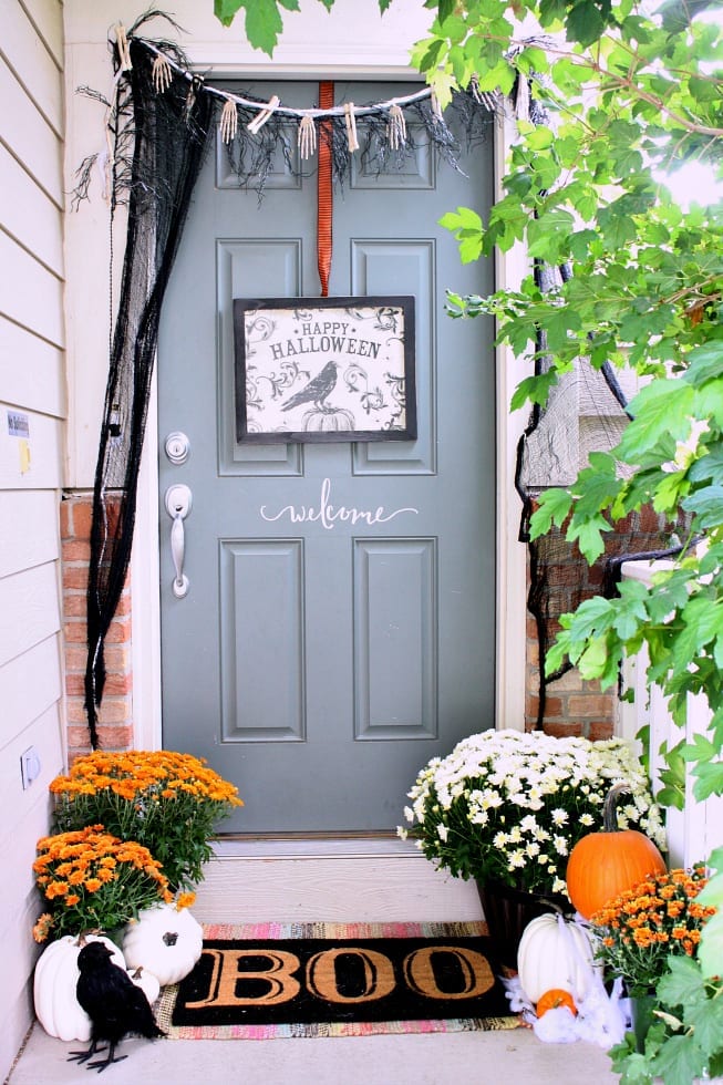 This Halloween decor idea features a spooky skeleton hanging from a chandelier, adding a creepy touch to any room. The black and white color scheme creates a haunting atmosphere, perfect for a Halloween party or just to scare visitors.
