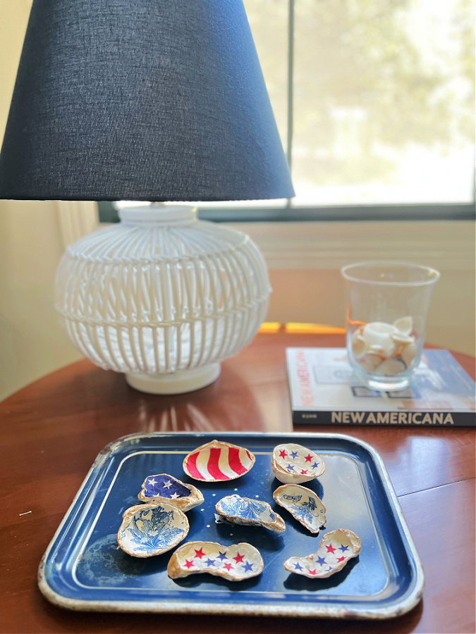 Patriotic mod podge sea shells displayed on table 