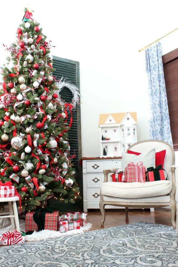 Our tree is full of red ribbon , mercury glass ornaments and pops of plaid!