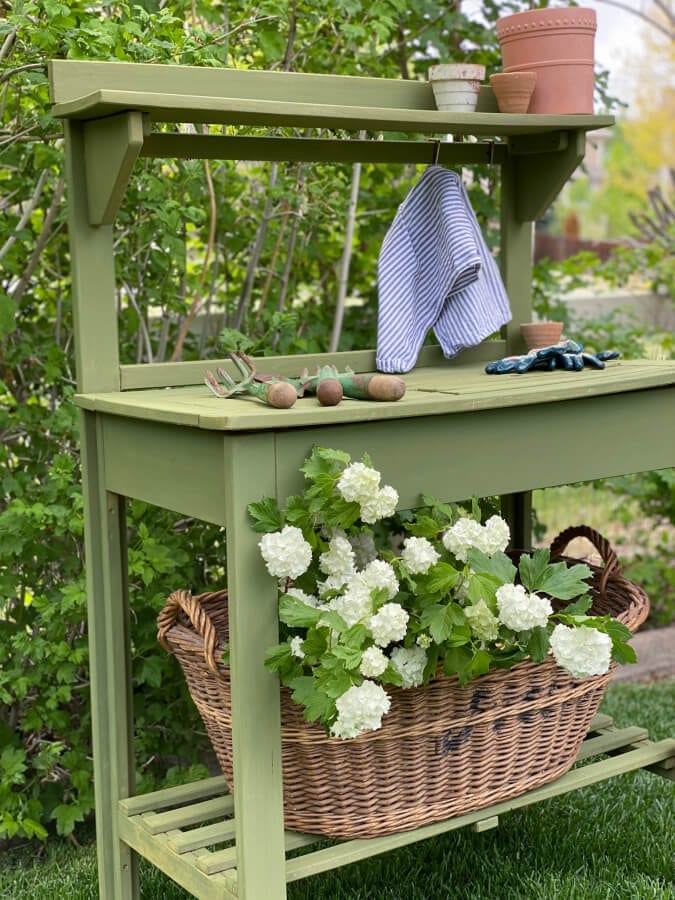 This World Market potting bench makeover got a fresh coat of Boxwood green milk paint!