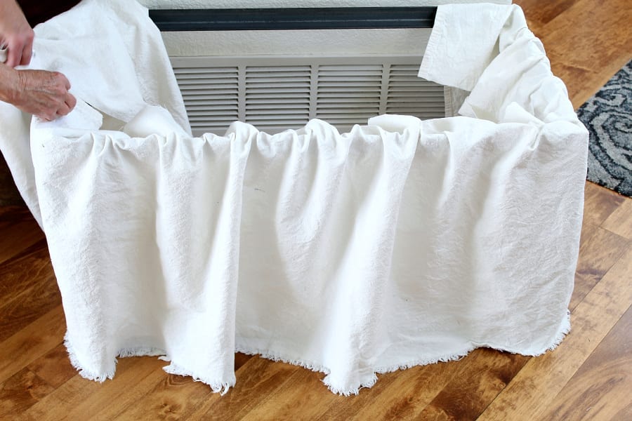 Spread your drop cloth around the bench's base to see if you have enought to make your skirt.