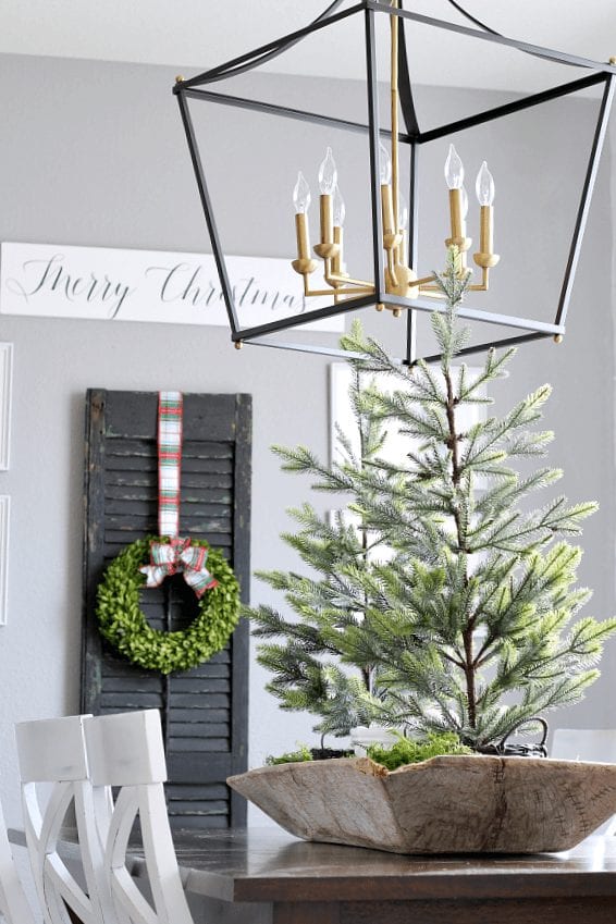 Wreaths, trees, greenery and shutters make this dining room Christmas ready!