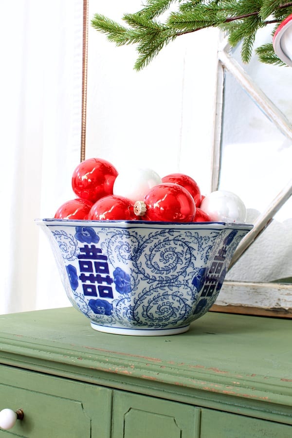 A simple way to decorate is to fill up a decorative bowl with Christmas ornaments.