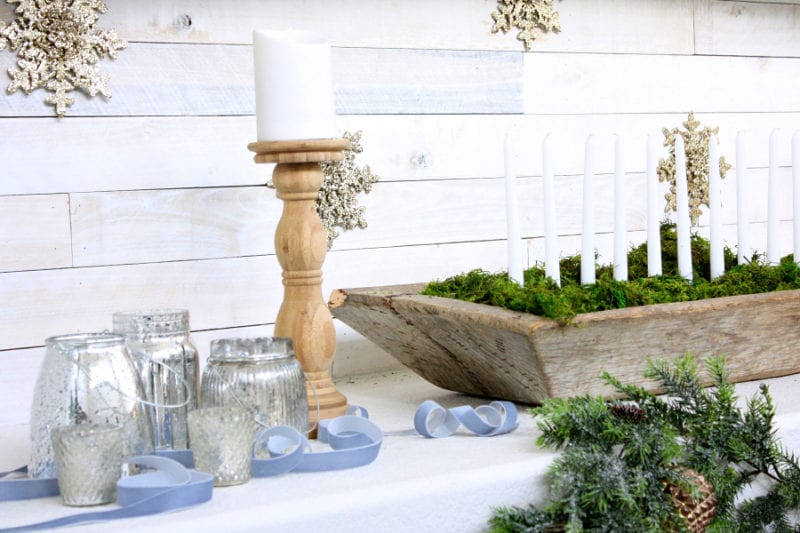 A beautiful rustic and elegant Christmas mantel with subtle pops of blue.