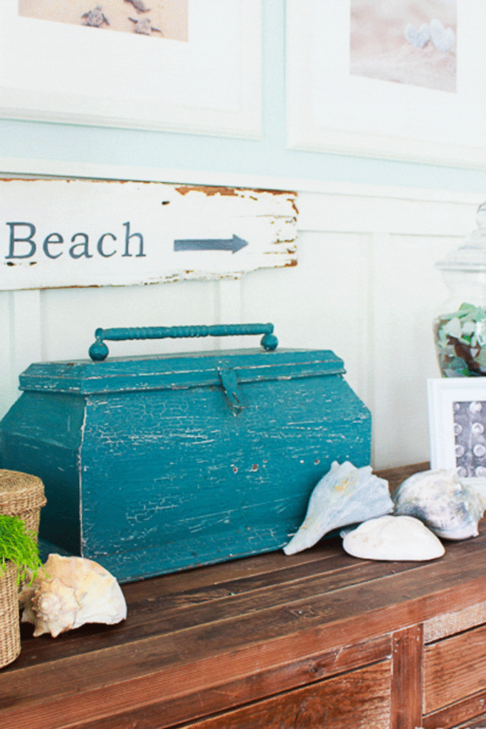 Welcome Home Saturday With Sand Dollar Lane | Welcome Home Saturday by popular Alabama lifestyle blog, She Gave It A Go: image of a blue distressed wooden box beneath a wooden beach sign and next to some seashells. 