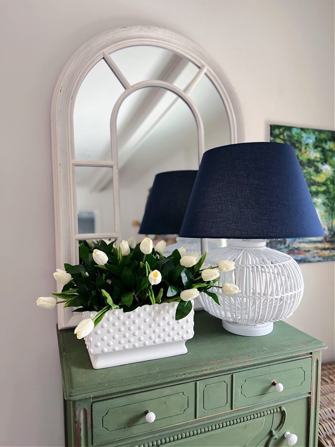 Simple Spring floral arrangement with tulips on green dresser
