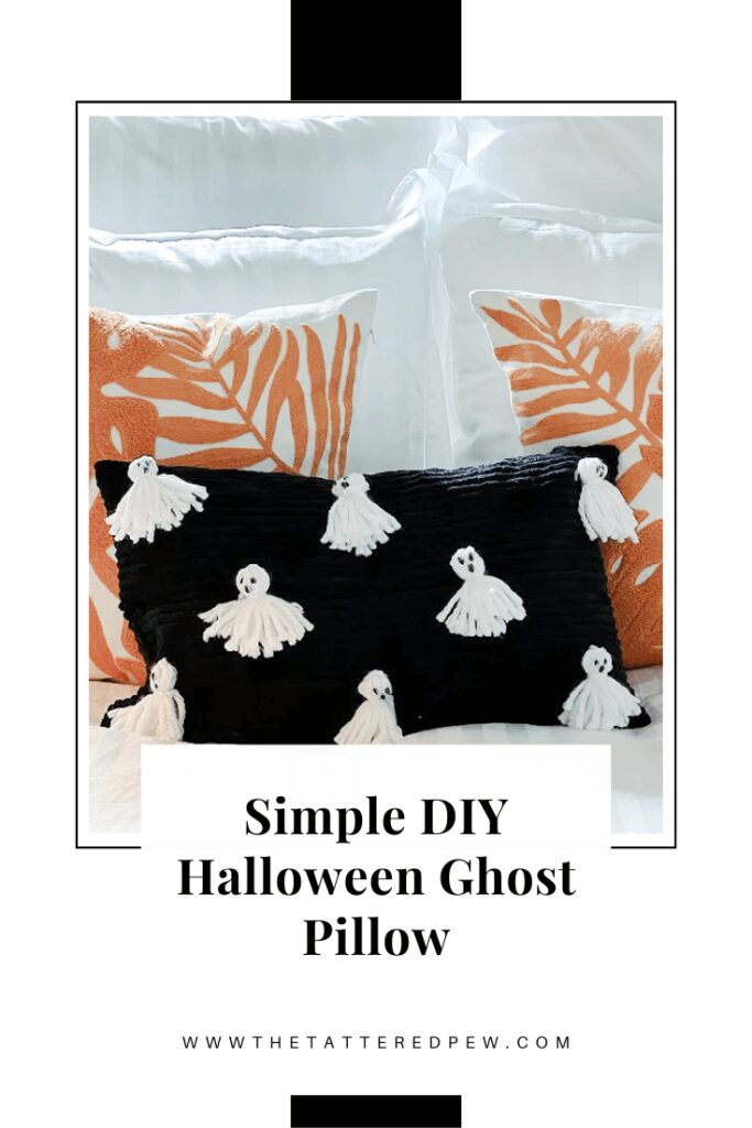 Black pillow with white ghosts on it surrounded by white and orange pillows