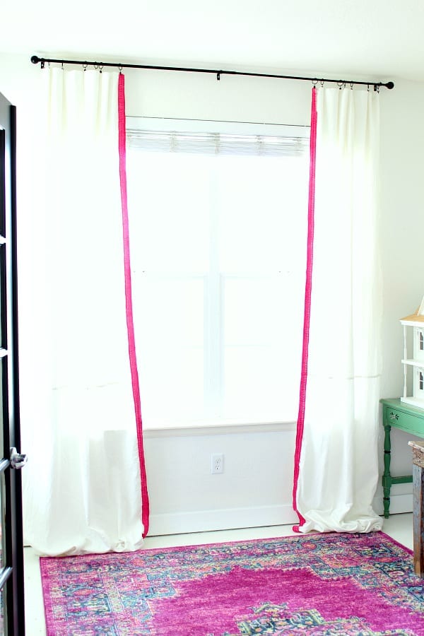 Simple no sew drop coth curtains with pink colorful trim.
