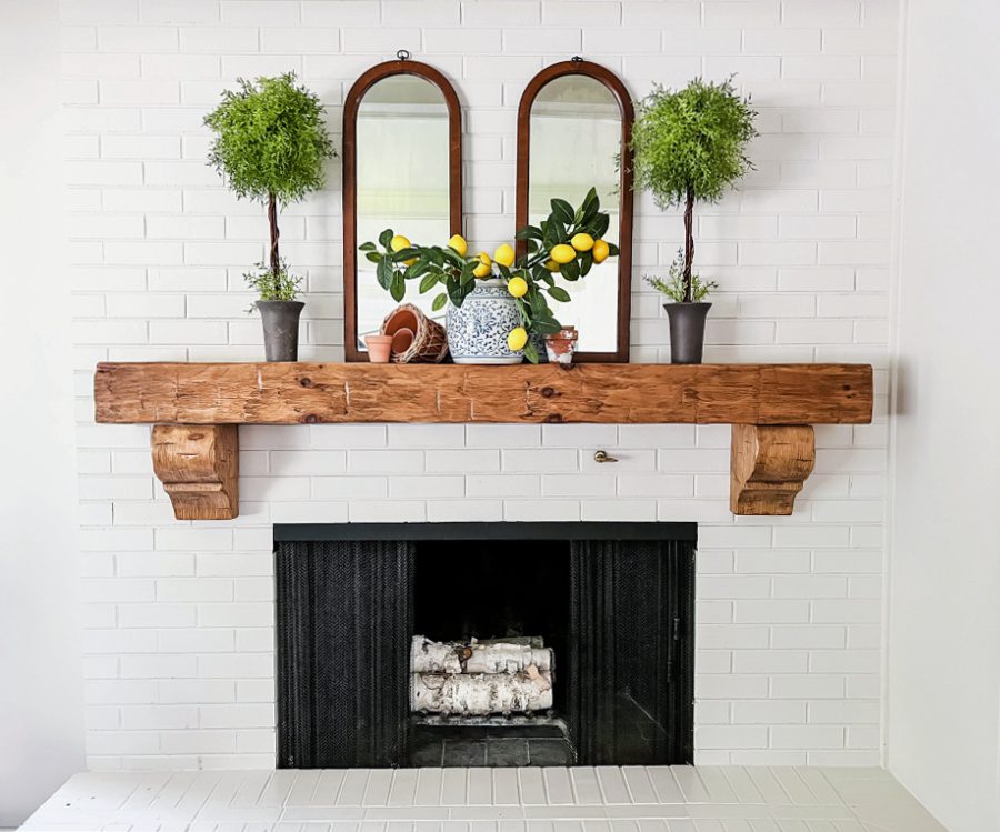A simple summer mantel with lemons, topiaries and mirrors.