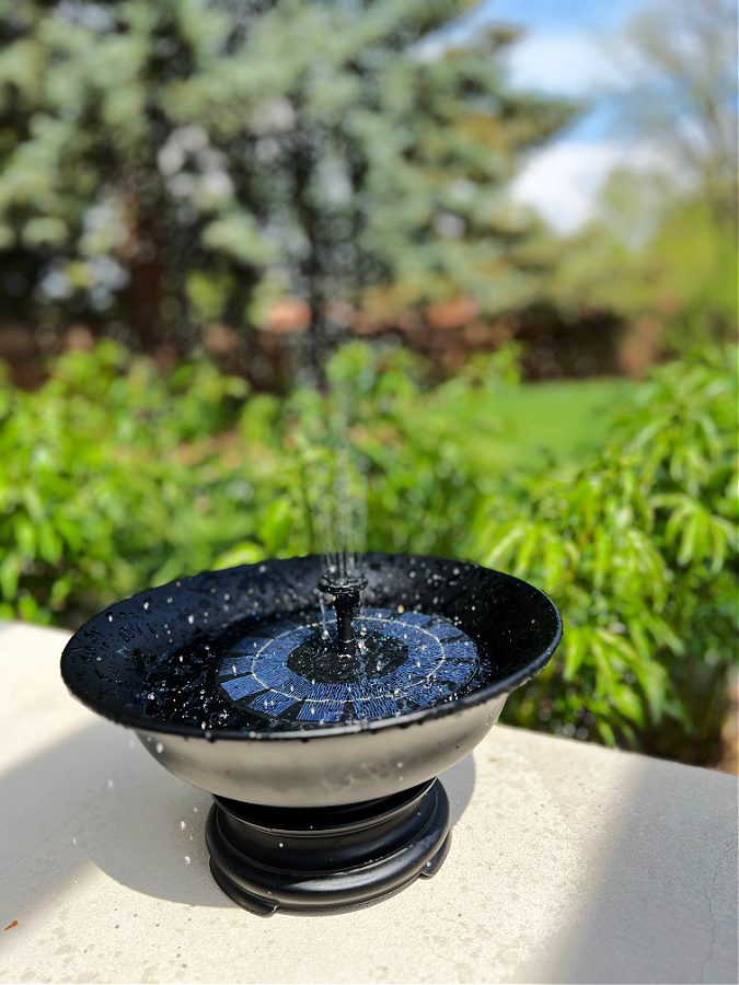 solar fountain in a black pedestal bowl