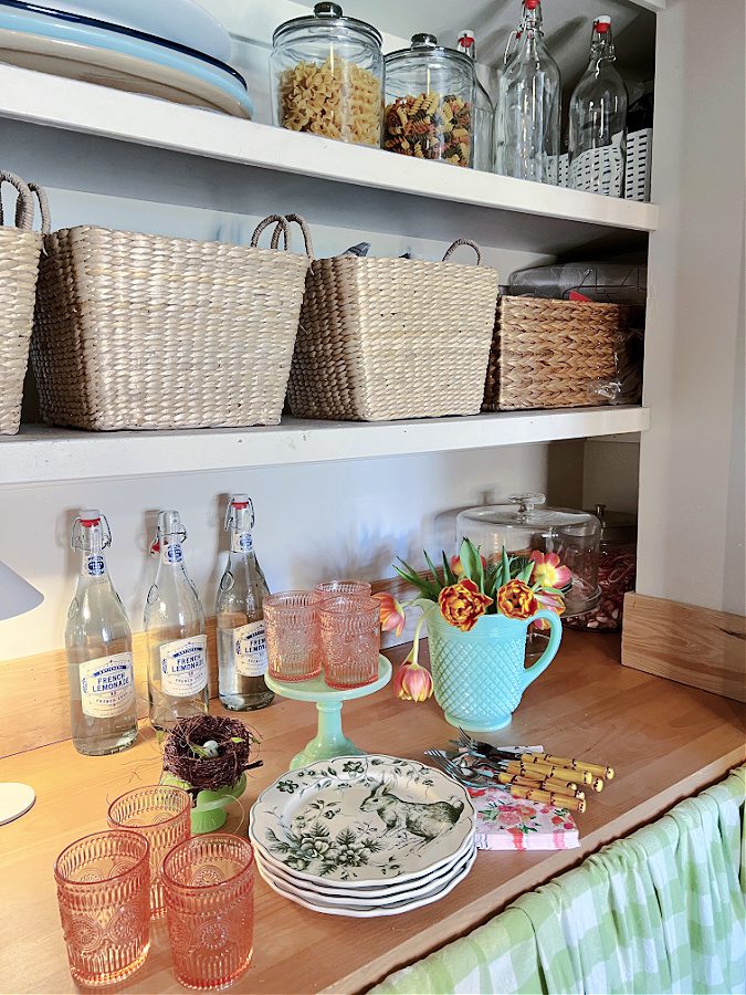 Pink and green decor on pantry counters made of wood.