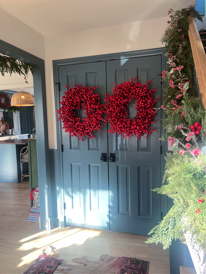 blue doors with red berry wreaths