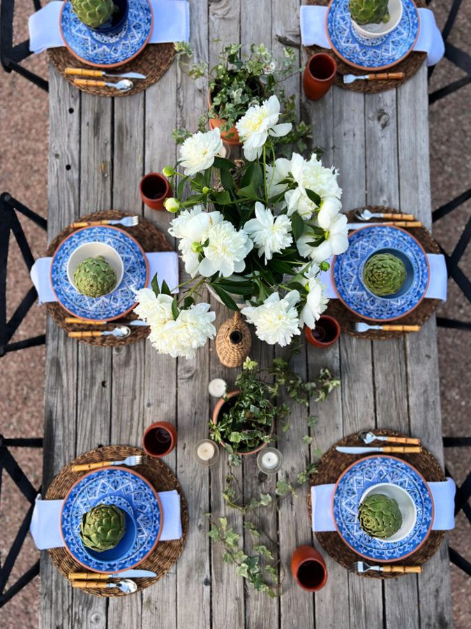 An outdoor summer tablescape using blues and terracotta accents.
