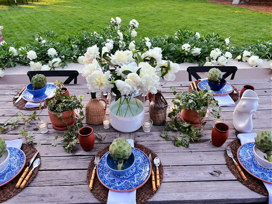 Summer dining outside with white peonies and blue plates!