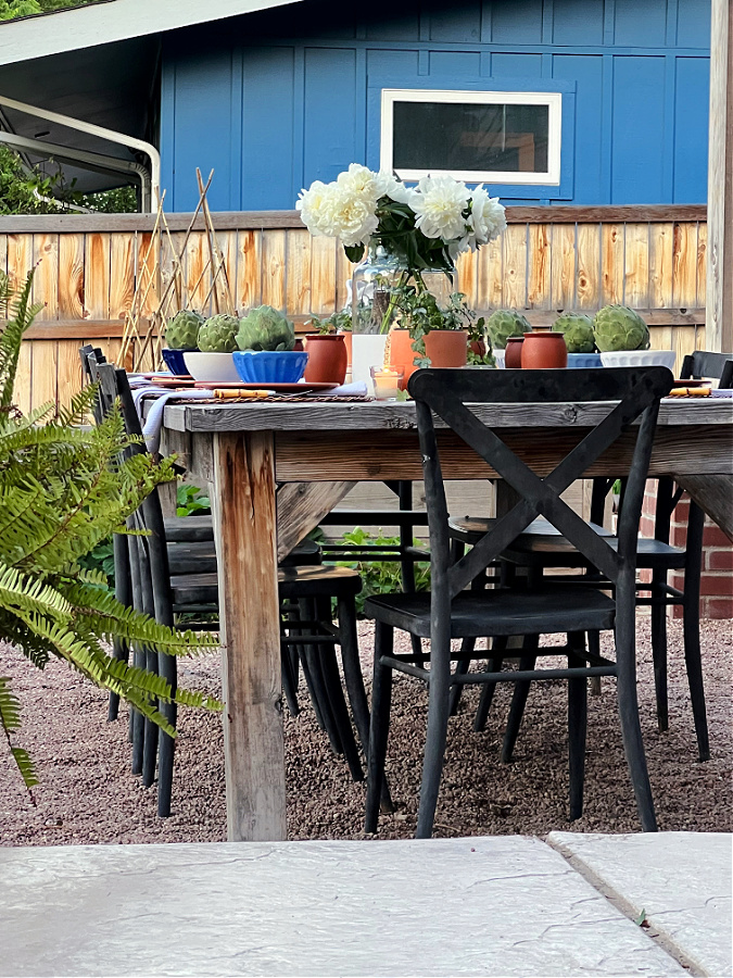 Our backyard table set for a summer dinner with blues and terracotta touches.