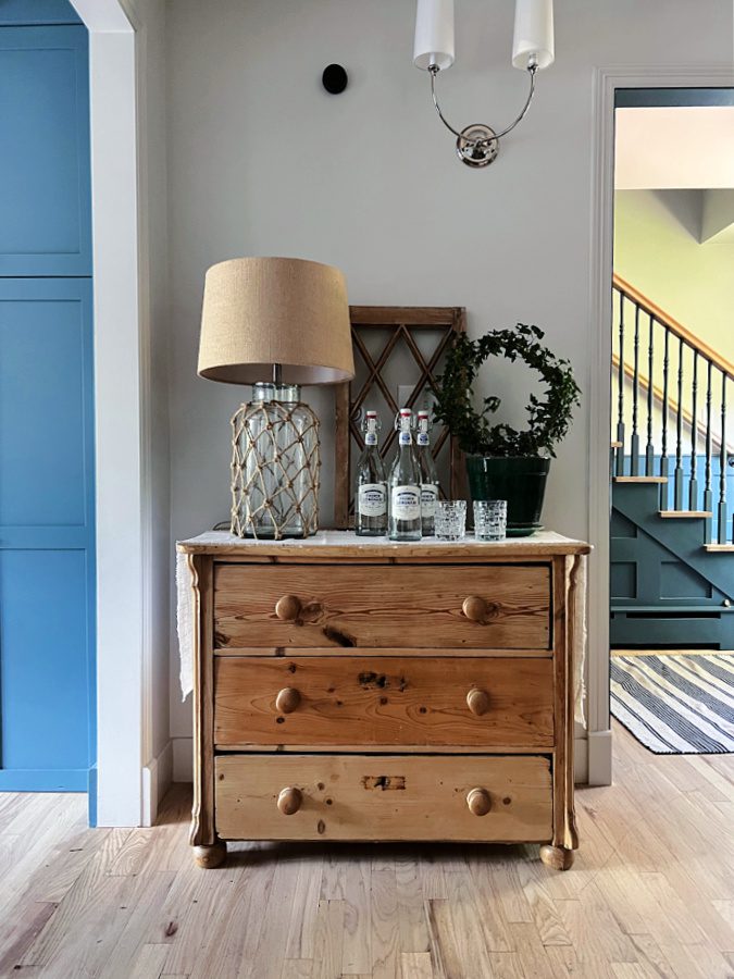 Entry way dresser with lamp and topiary