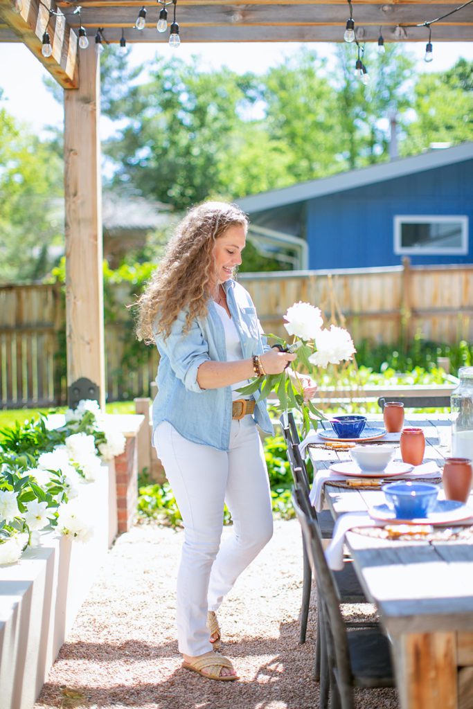 Setting our outdoor table in our backyard and using white peonies!