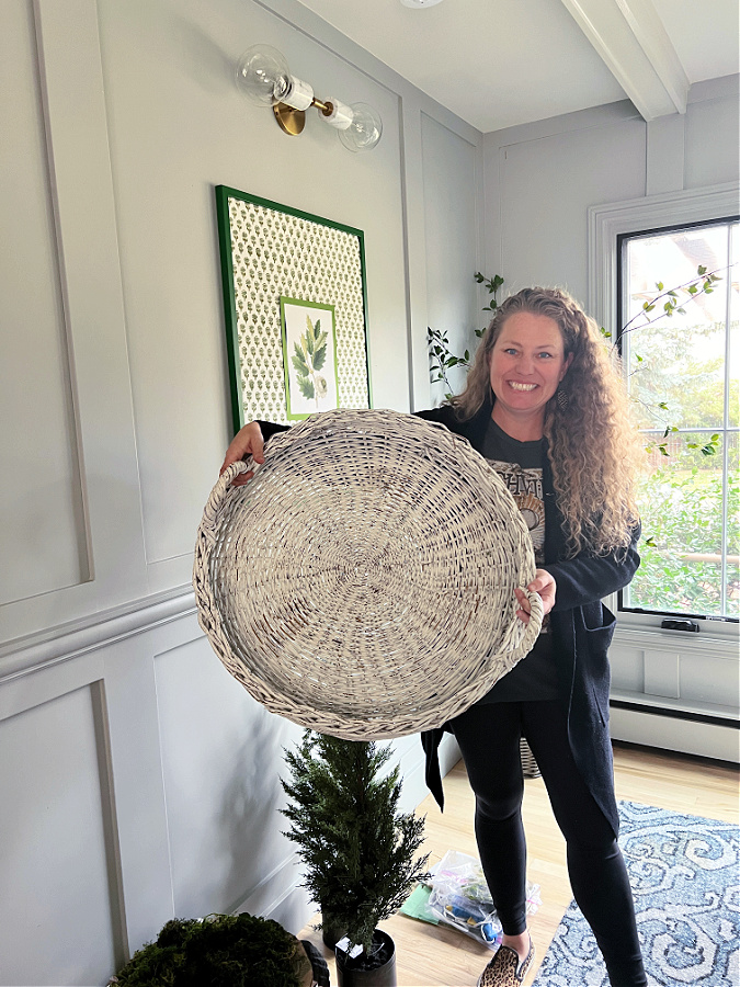 me holding large white wicker basket tray