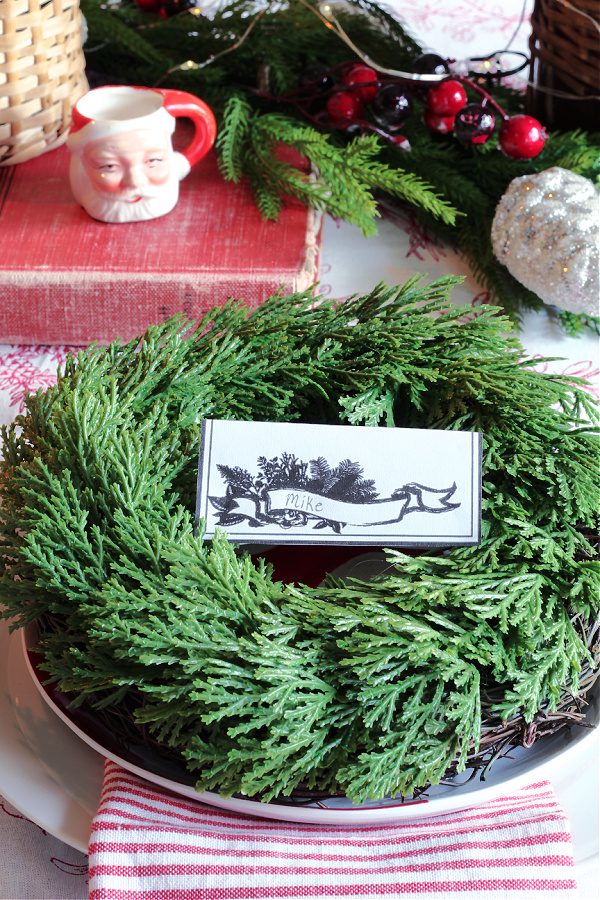 Simple place setting for a Christmas tablescape with wreaths.