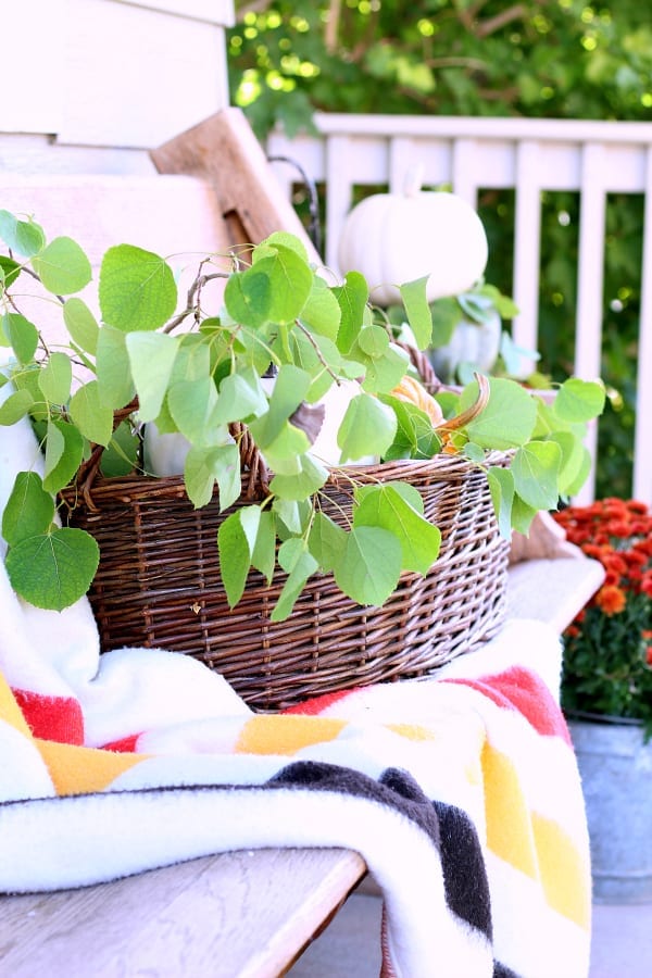 This imitation Hudson Bay blanket and basket are the perfect pair for this Fall porch.