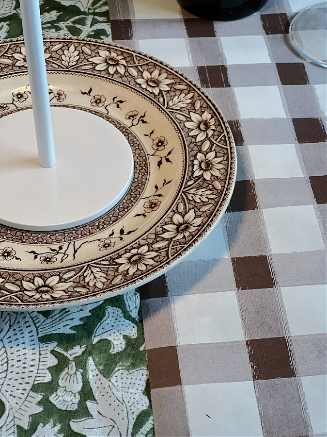 layered vintage plates mismatched on Thanksgiving table