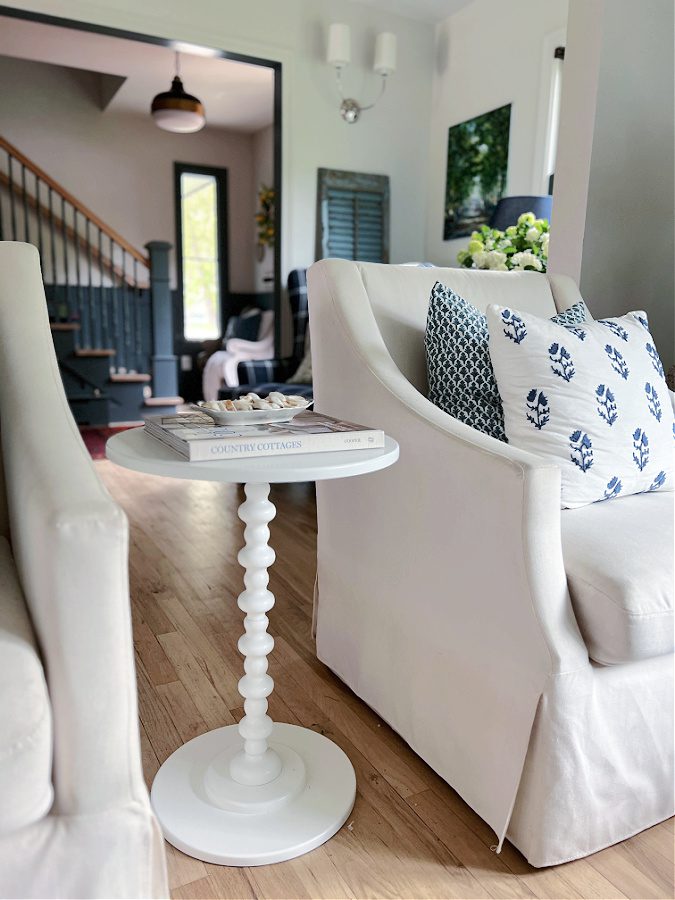 Blue and white block print pillows on white chairs