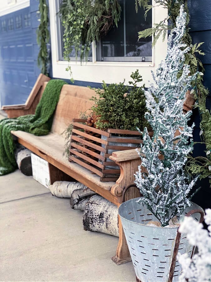 green, white and natural wood tones make for a cozy winter porch look!