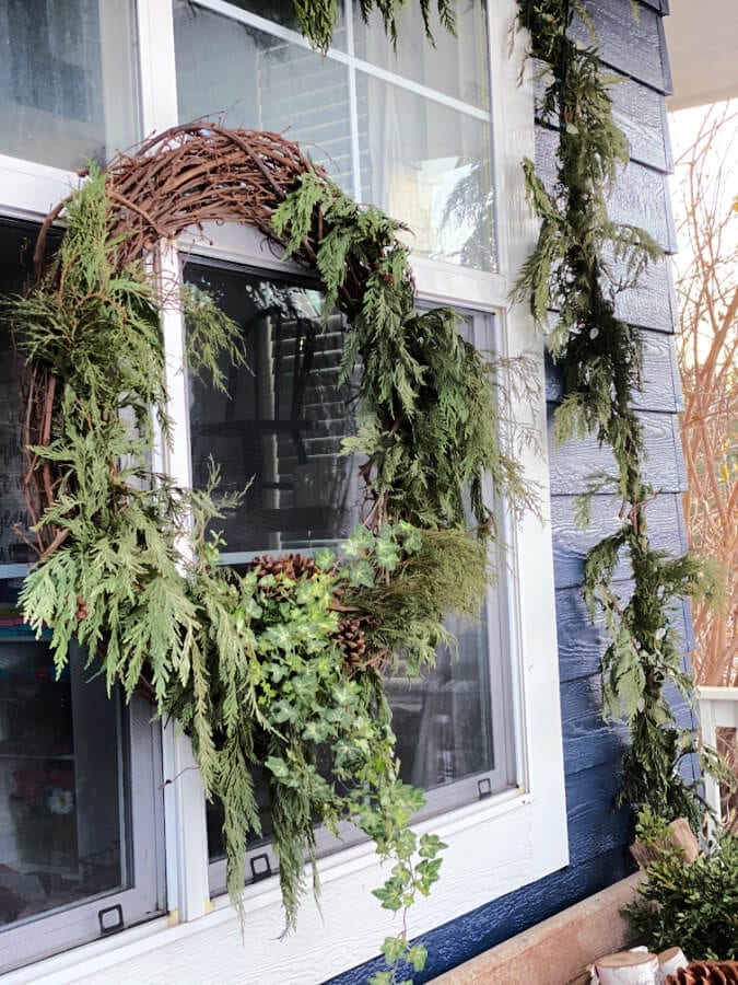 Winter greenery wreath steal the show on this winter porch!